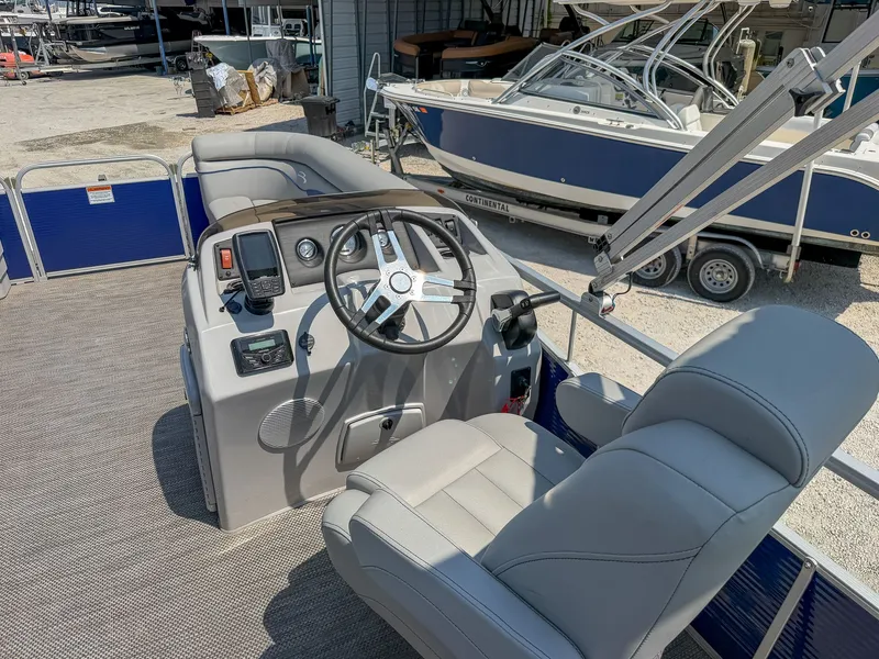 Slide: The Image of The image shows the cockpit of a 2024 Bennington 20 SVL with gray seats and a modern helm. - 11