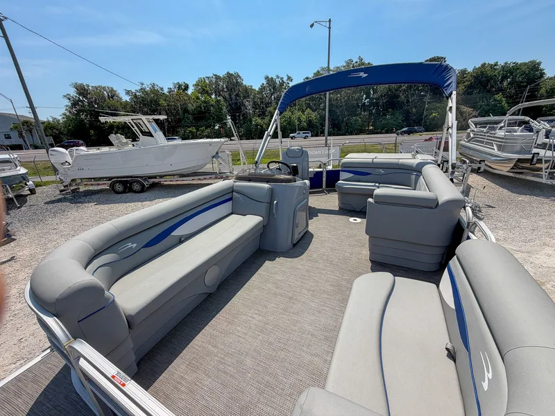 Slide: The Image of The image shows a 2024 Bennington 20 SVL pontoon boat with gray seating and blue accents. - 5