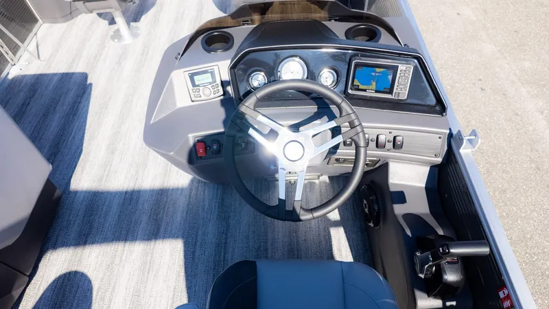 Slide: The Image of The image shows the helm of a Bennington 18 S Fish and Cruise boat with modern instruments. - 15