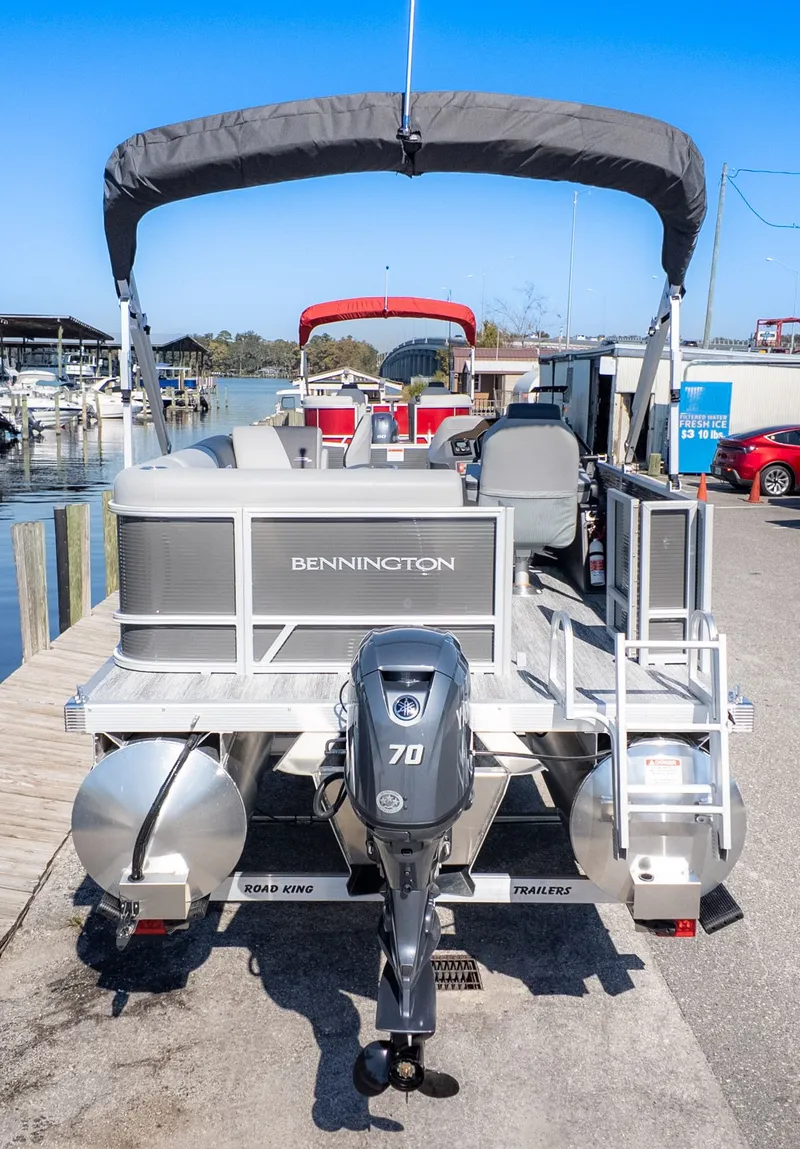Slide: The Image of Bennington 18 S Fish and Cruise pontoon boat at dock with outboard motor. - 4