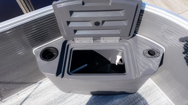 Slide: The Image of A gray storage compartment on a boat with two cup holders. - 9