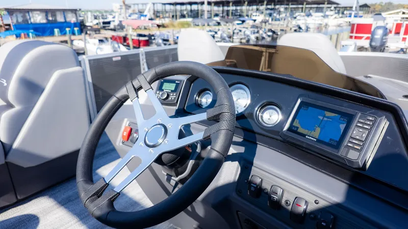 Slide: The Image of The image shows the helm of a Bennington 18 S Fish and Cruise boat with modern instruments. - 16
