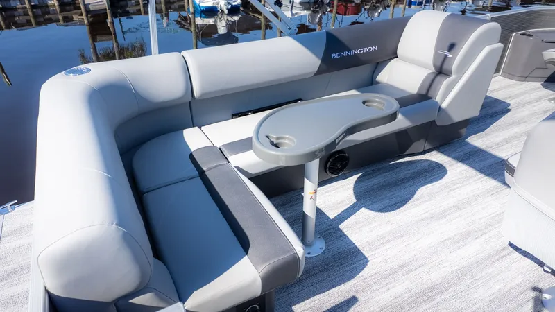 Slide: The Image of 2026 Bennington 18 S Fish and Cruise with gray upholstery and a table with cup holders. - 5