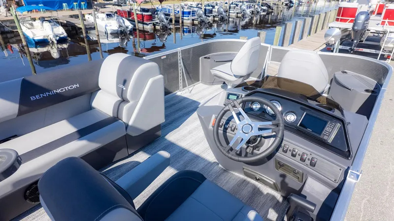 Slide: The Image of The image shows the cockpit of a Bennington 18 S Fish and Cruise boat with modern seating and controls. - 14