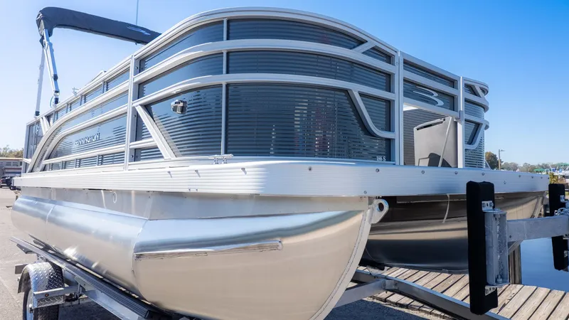 Slide: The Image of Bennington 18 S Fish and Cruise pontoon boat on a trailer at the dock. - 3