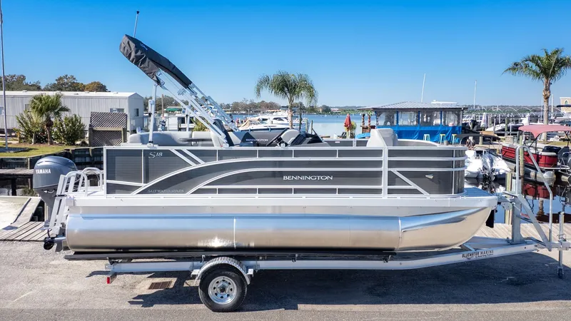 Slide: The Image of Bennington 18 S Fish and Cruise pontoon boat on a trailer, ready for adventure. - 15
