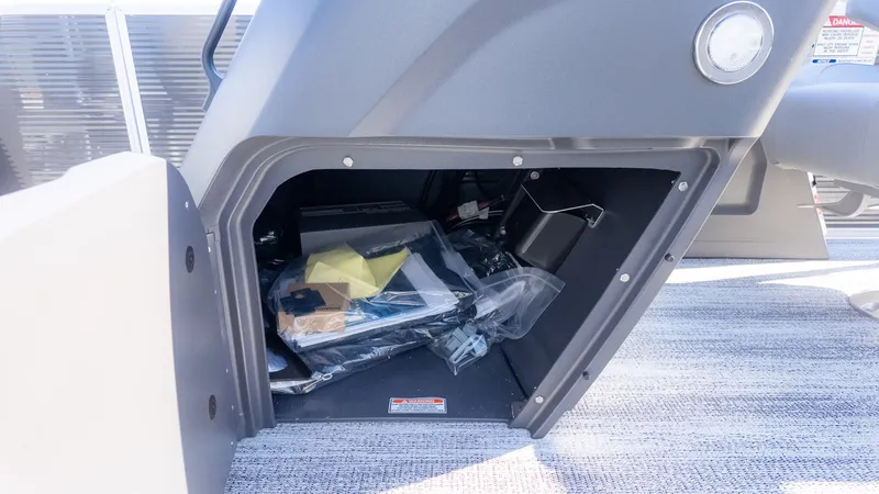 Slide: The Image of Cockpit storage compartment with various items on a gray floor. - 10