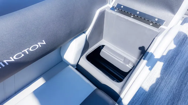 Slide: The Image of Interior view of a Bennington boat with gray seating and storage compartment. - 5