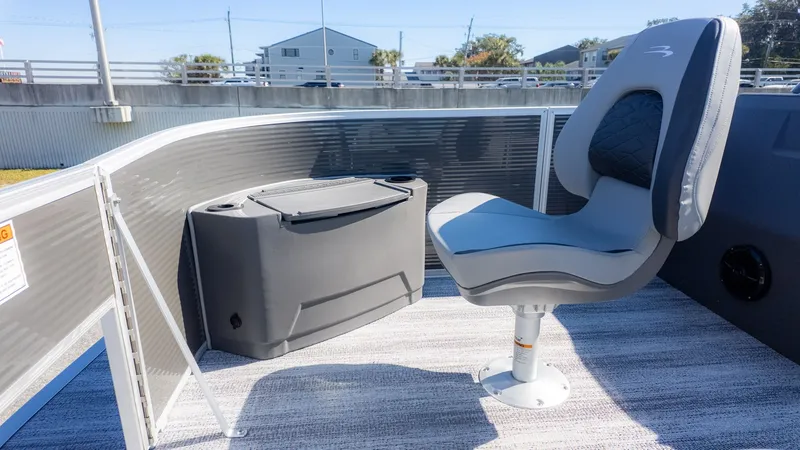 Slide: The Image of A seat on a boat with gray flooring and a small console beside it. - 8