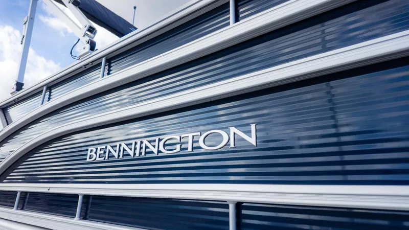Slide: The Image of Close-up of a blue Bennington boat hull with the brand name visible. - 3