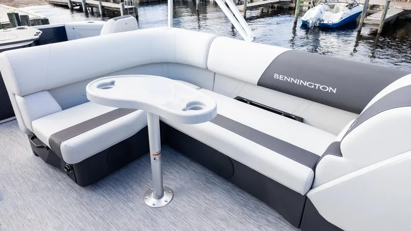 Slide: The Image of The image shows the seating area of a Bennington 20 S Fishing boat with gray and white upholstery. - 9