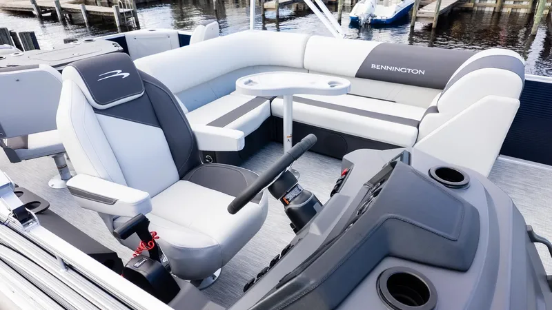 Slide: The Image of The image shows the cockpit of a Bennington 20 S Fishing boat with comfortable seating and a table. - 20