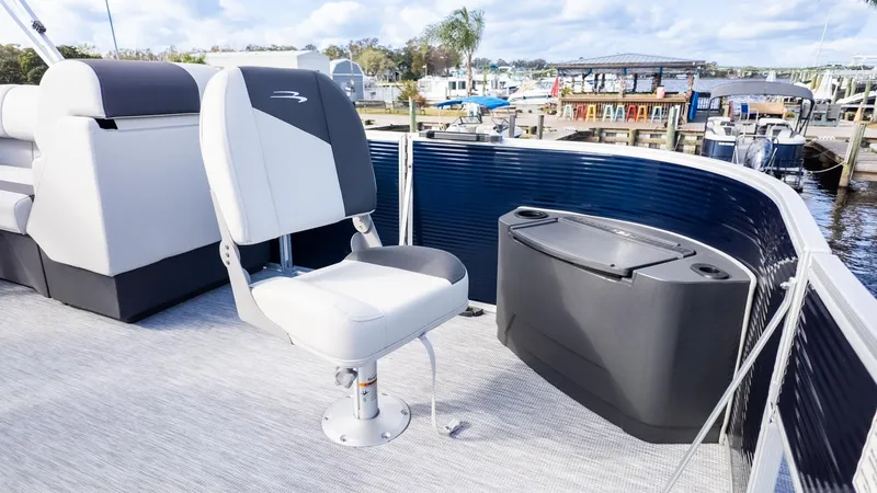 Slide: The Image of The image shows the deck of a Bennington 20 S Fishing boat with a seat and storage. - 13