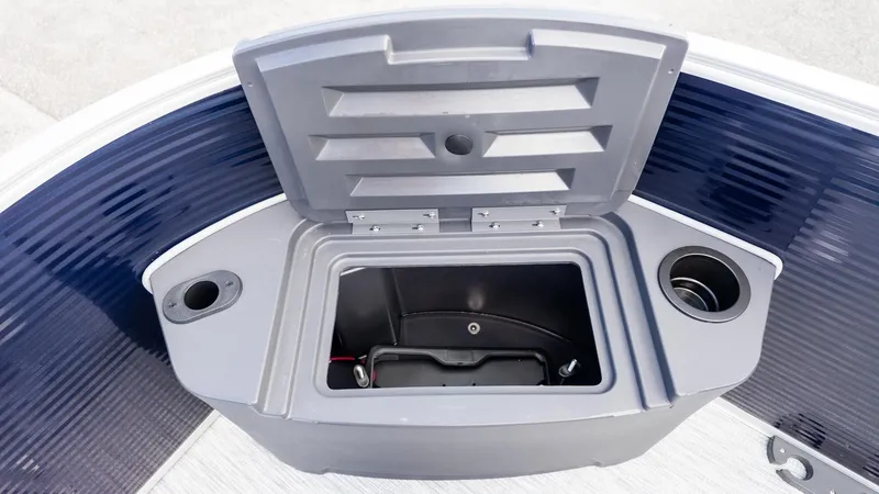 Slide: The Image of The image shows a gray storage compartment on a boat with cup holders. - 16