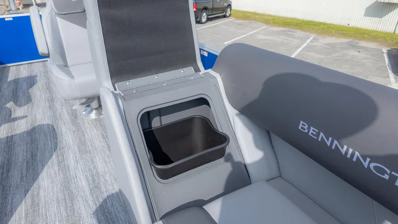 Slide: The Image of Interior of a Bennington 20SSRSE boat with gray seating and built-in storage. - 15