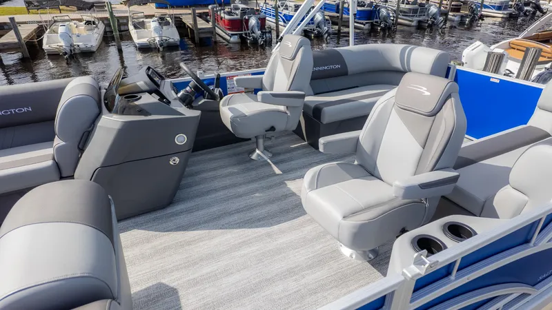 Slide: The Image of The image shows the interior of a Bennington 20SSRSE pontoon boat with gray seating and a steering wheel. - 3