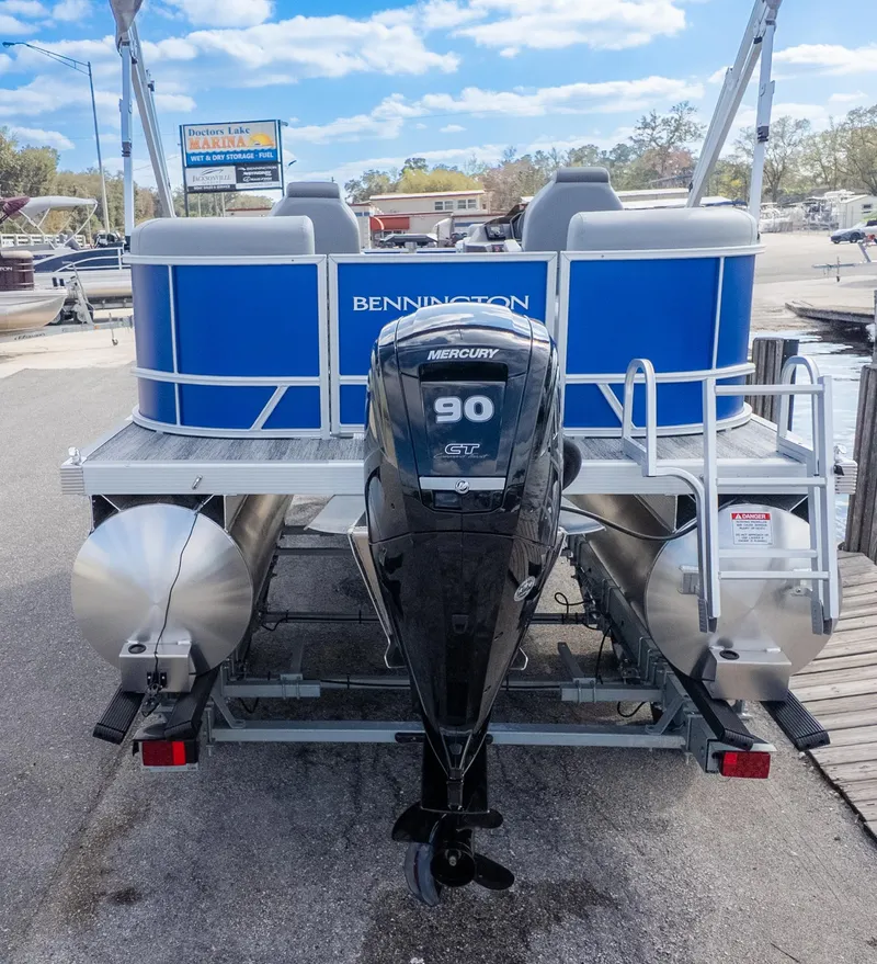 Slide: The Image of Bennington 20SSRSE pontoon boat with Mercury 90 HP engine, parked at a dock. - 6