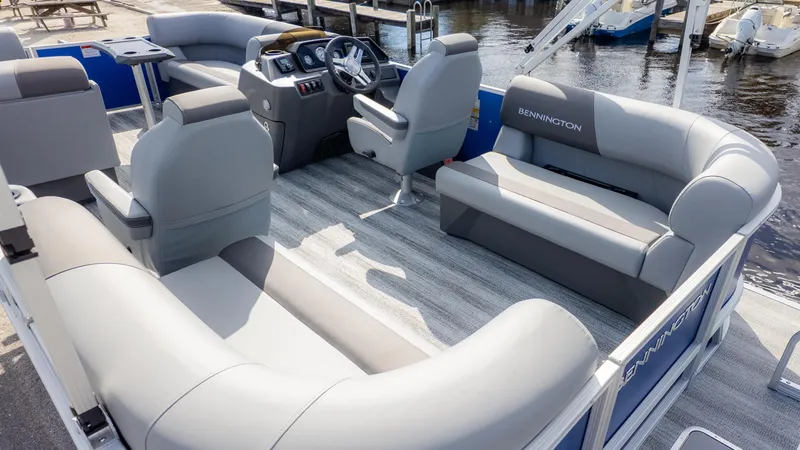 Slide: The Image of Interior view of a Bennington 20SSRSE pontoon boat with gray seating and a helm station. - 4
