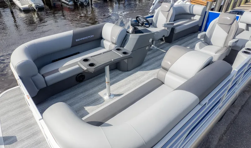 Slide: The Image of The image shows the interior of a 2025 Bennington 20SSRSE pontoon boat with gray seating. - 21