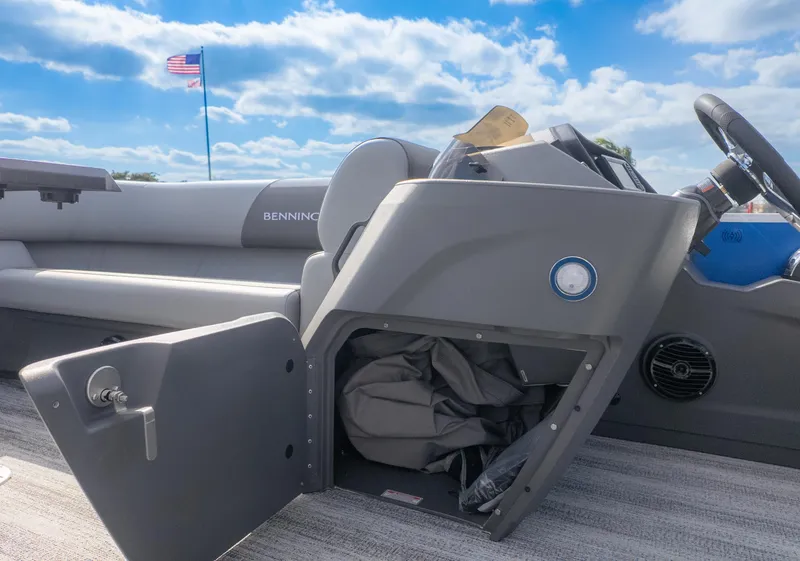 Slide: The Image of The image shows the cockpit of a Bennington 20SSRSE boat with an open storage compartment. - 14