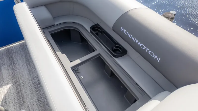 Slide: The Image of The image shows a gray bench seat on a boat with storage underneath. - 12