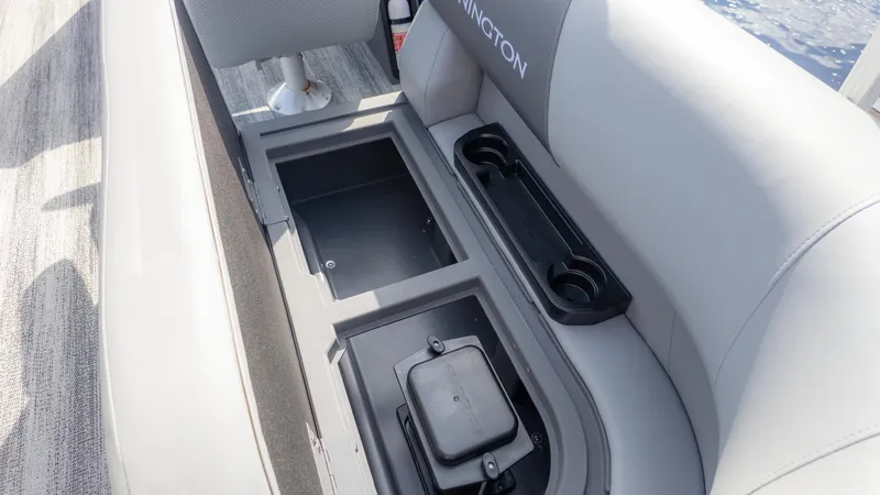 Slide: The Image of The image shows a gray boat seat with built-in storage and cup holders. - 6