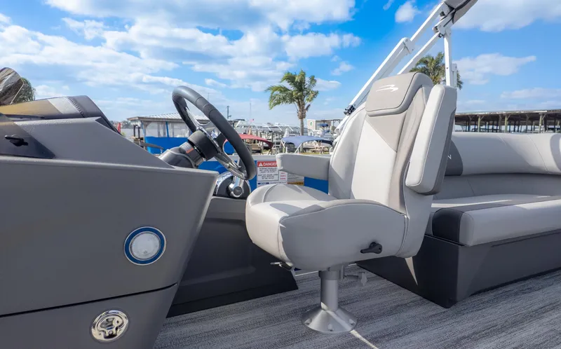 Slide: The Image of The image shows the cockpit of a Bennington 20SSRSE pontoon boat with a comfortable captain's chair. - 15