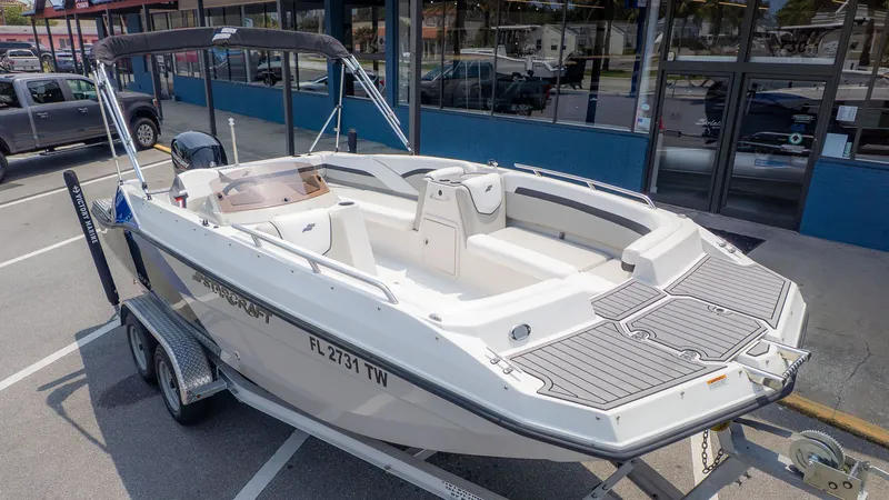 Slide: The Image of A 2023 Starcraft 191SVX boat on a trailer, parked in a lot. - 22