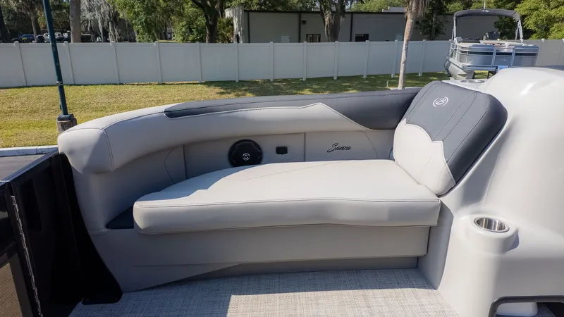 Slide: The Image of The image shows a luxurious seating area on a Barletta Sanza 20L boat, surrounded by a well-kept outdoor area. - 14