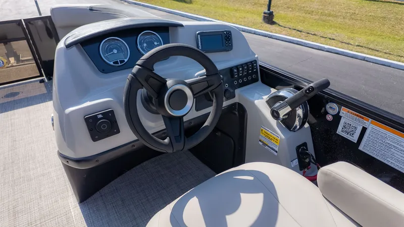 Slide: The Image of The image shows the helm of a Barletta Sanza 20L boat with modern instruments. - 17