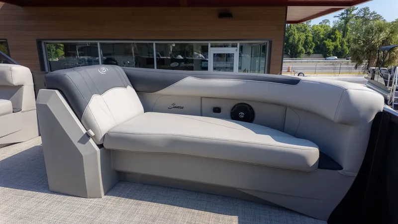 Slide: The Image of The image shows a luxurious gray seating area on a boat, surrounded by lush greenery. - 11