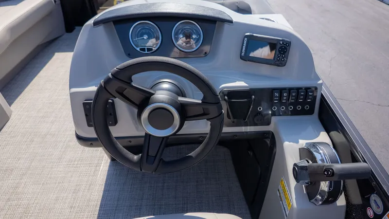 Slide: The Image of The image shows the helm of a Barletta Sanza 20L boat with a steering wheel and instruments. - 18