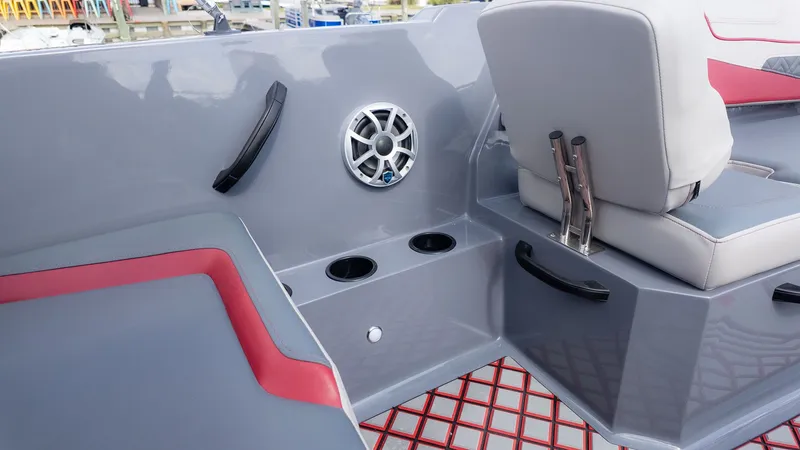 Slide: The Image of The image shows the gray and red interior of a Starcraft J7 Jet Super Sport boat with cup holders and speaker. - 5