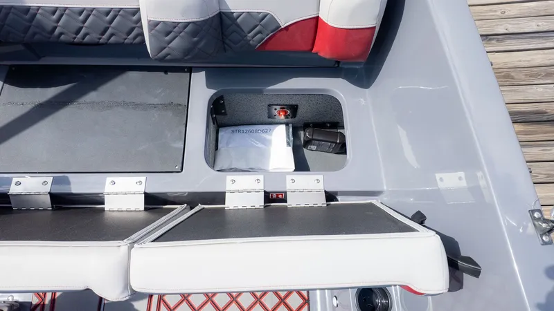 Slide: The Image of The image shows the seating area of a Starcraft J7 Jet Super Sport boat with storage. - 4