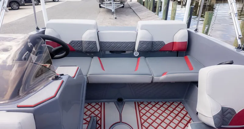 Slide: The Image of The image shows the interior of a modern boat with gray and red upholstery. - 3