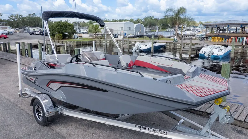 Slide: The Image of A gray Starcraft J7 Jet Super Sport boat on a trailer by the water. - 15