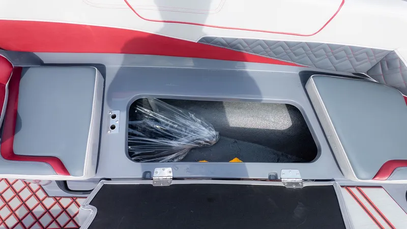 Slide: The Image of Interior view of a boat with gray and red upholstery and an open storage compartment. - 7