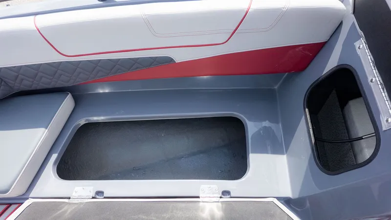 Slide: The Image of Interior view of a modern boat with gray and red upholstery and storage space. - 9