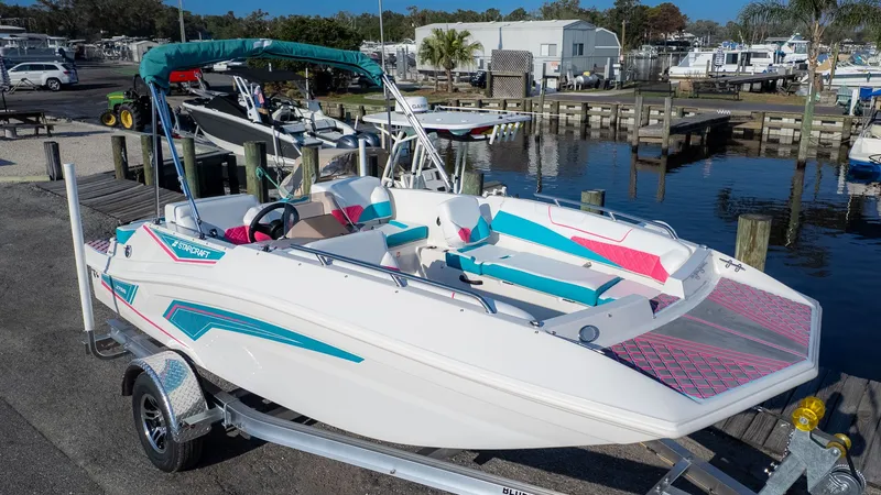 Slide: The Image of A white 2027 Starcraft J7 Jet Super Sport boat on a trailer near a marina. - 16