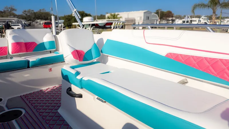 Slide: The Image of The boat features colorful upholstery in pink and turquoise, with white accents and a modern design. - 5