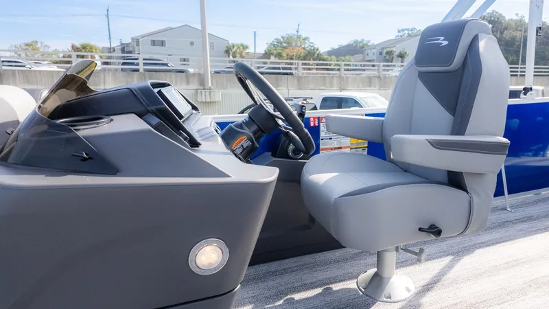 Slide: The Image of The image shows the helm of a 2026 Bennington 21 S Fish and Cruise boat with a gray captain's chair. - 15