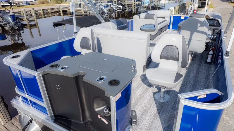Slide: The Image of Bennington 21 S Fish and Cruise 2026: Spacious pontoon boat with blue sides and comfortable seating. - 3