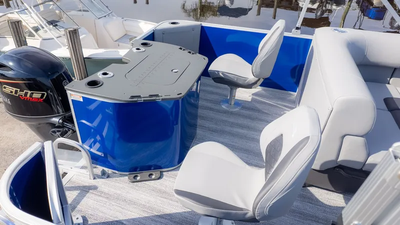 Slide: The Image of The image shows the cockpit of a 2026 Bennington 21 S Fish and Cruise boat with blue accents. - 4