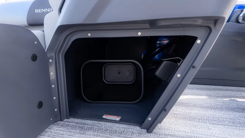 Slide: The Image of Storage compartment inside a Bennington boat with gray carpeting. - 14