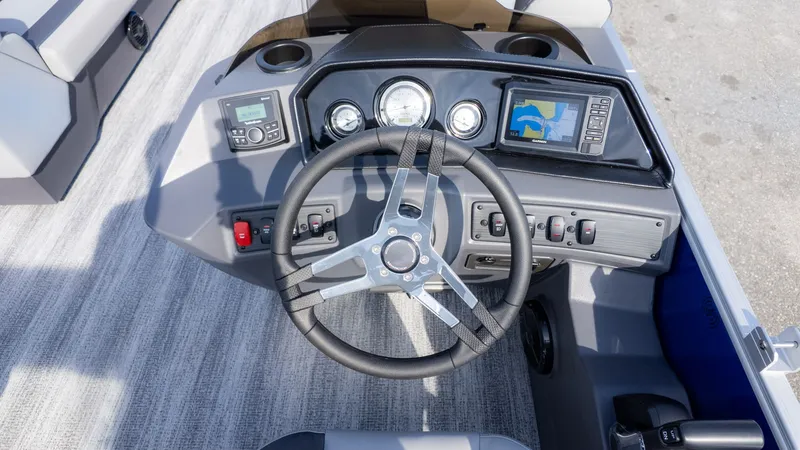 Slide: The Image of The image shows the helm of a Bennington 21 S Fish and Cruise boat with modern instruments. - 16