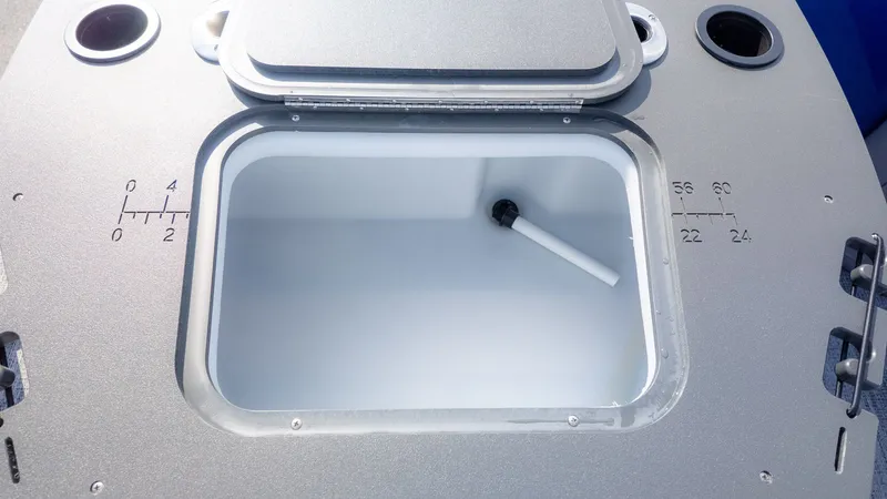 Slide: The Image of Bennington 21 S FISH AND CRUISE 2026: Detail of an open storage compartment with measurement scales. - 6