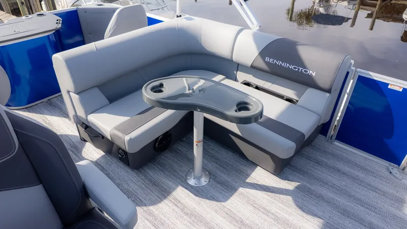 Slide: The Image of Interior view of a Bennington 21 S Fish and Cruise boat with gray seating and a table. - 6