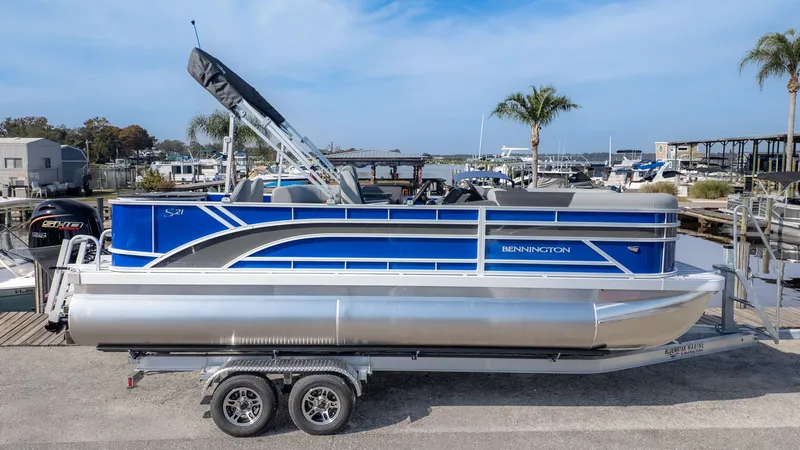 Slide: The Image of Bennington 21 S Fish and Cruise 2026 on a trailer at the marina. - 16