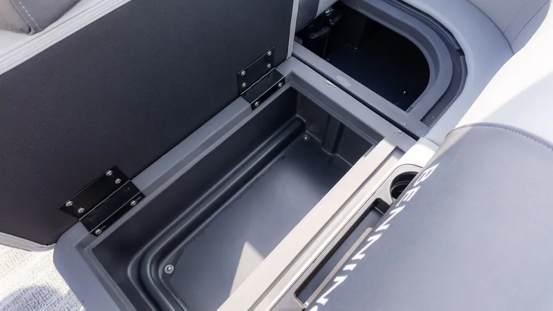 Slide: The Image of An open storage compartment on a Bennington boat, featuring sturdy hinges and a cup holder. - 7