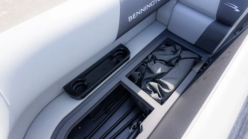 Slide: The Image of Interior view of a Bennington boat with storage compartment and cup holders. - 12